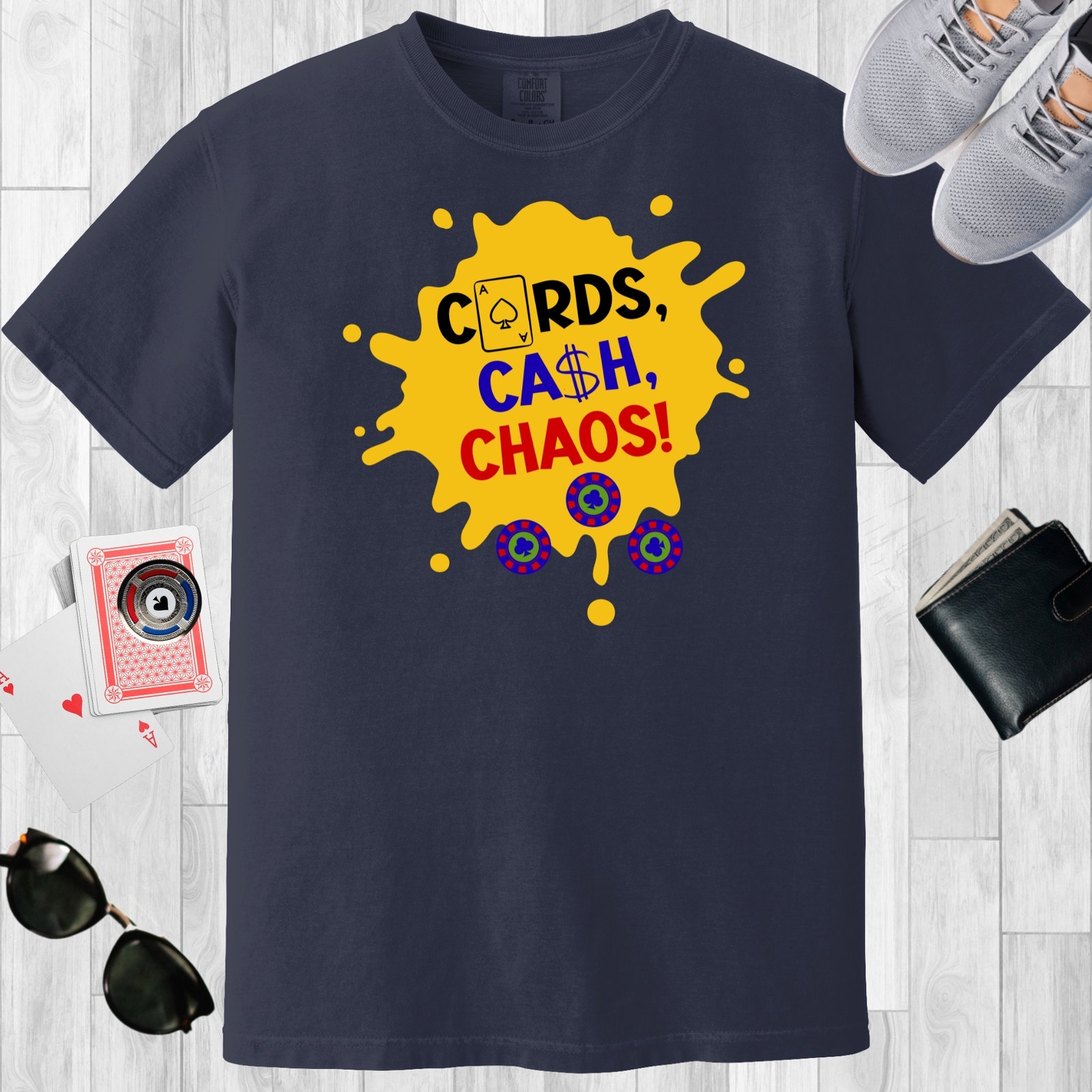 Navy colored unisex crewneck poker-themed T-shirt. Design features the text 'Cards, Cash, Choas'. The text and a few poker chips are positioned over a yellow paint splotch.