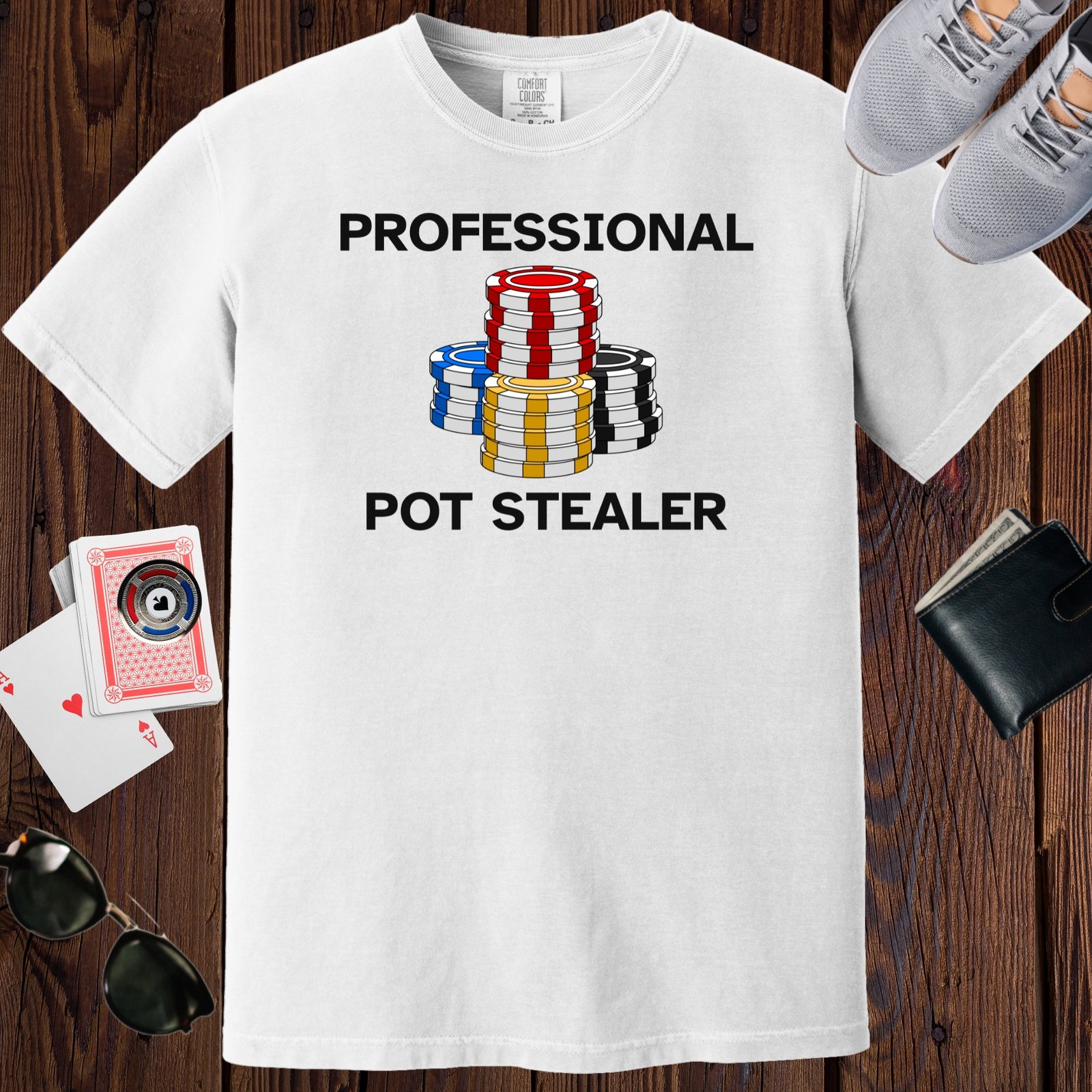 White colored unisex crewneck poker-themed T-shirt. Design features the text 'Professional Pot Stealer'. Image of poker chip stacks.