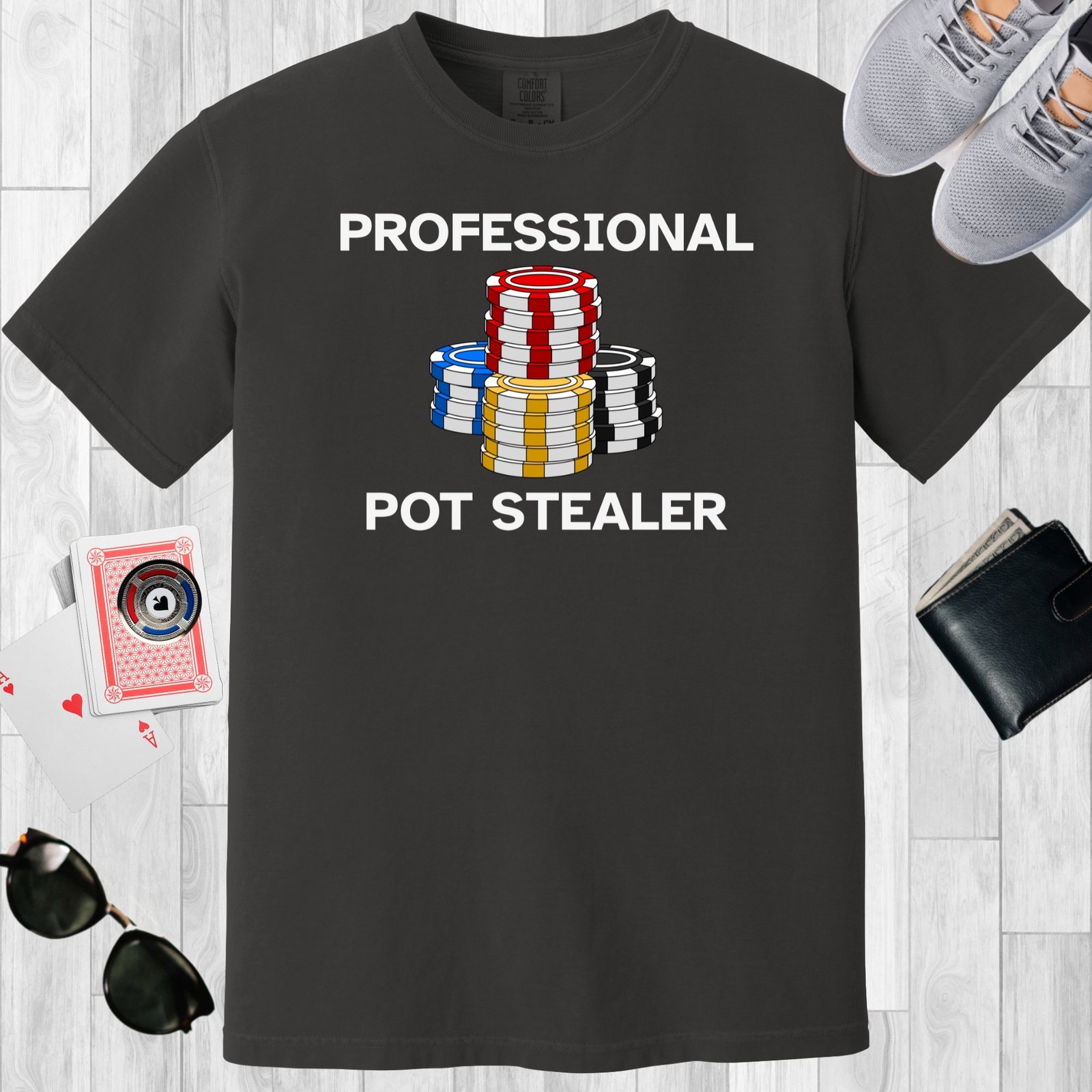 Graphite colored unisex crewneck poker-themed T-shirt. Design features the text 'Professional Pot Stealer'. Image of poker chip stacks.